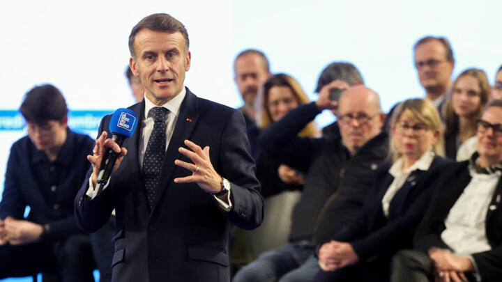 France's President Emmanuel Macron addresses the audience during a meeting with readers of the daily newspaper "La Voix du Nord" in Arras, northern France, on November 19, 2025.