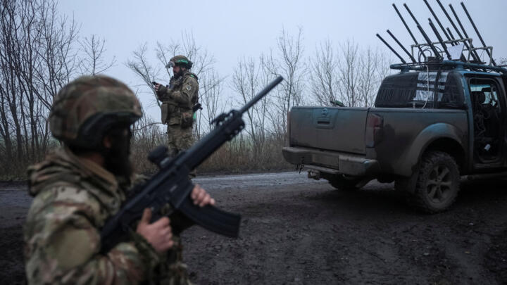 A serviceman of the 93rd Kholodnyi Yar Separate Mechanized Brigade of the Ukrainian Armed Forces checks the sky as he looks out for Russian combat drones.
