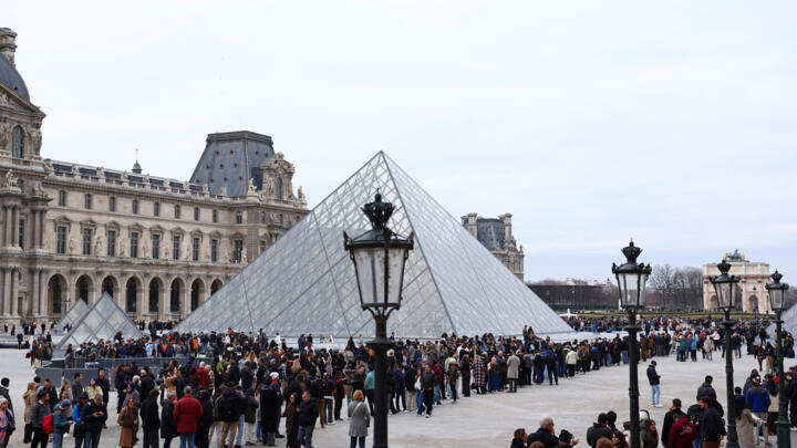 People queue to enter the Louvre which remains closed as its staff continue discussions on whether to extend a strike over pay and working conditions in Dec. 2025.