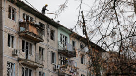 Emergency responders work at the site of a Russian drone strike on an apartment building, amid Russia's attack on Ukraine, in Kyiv, Ukraine December 23, 2025