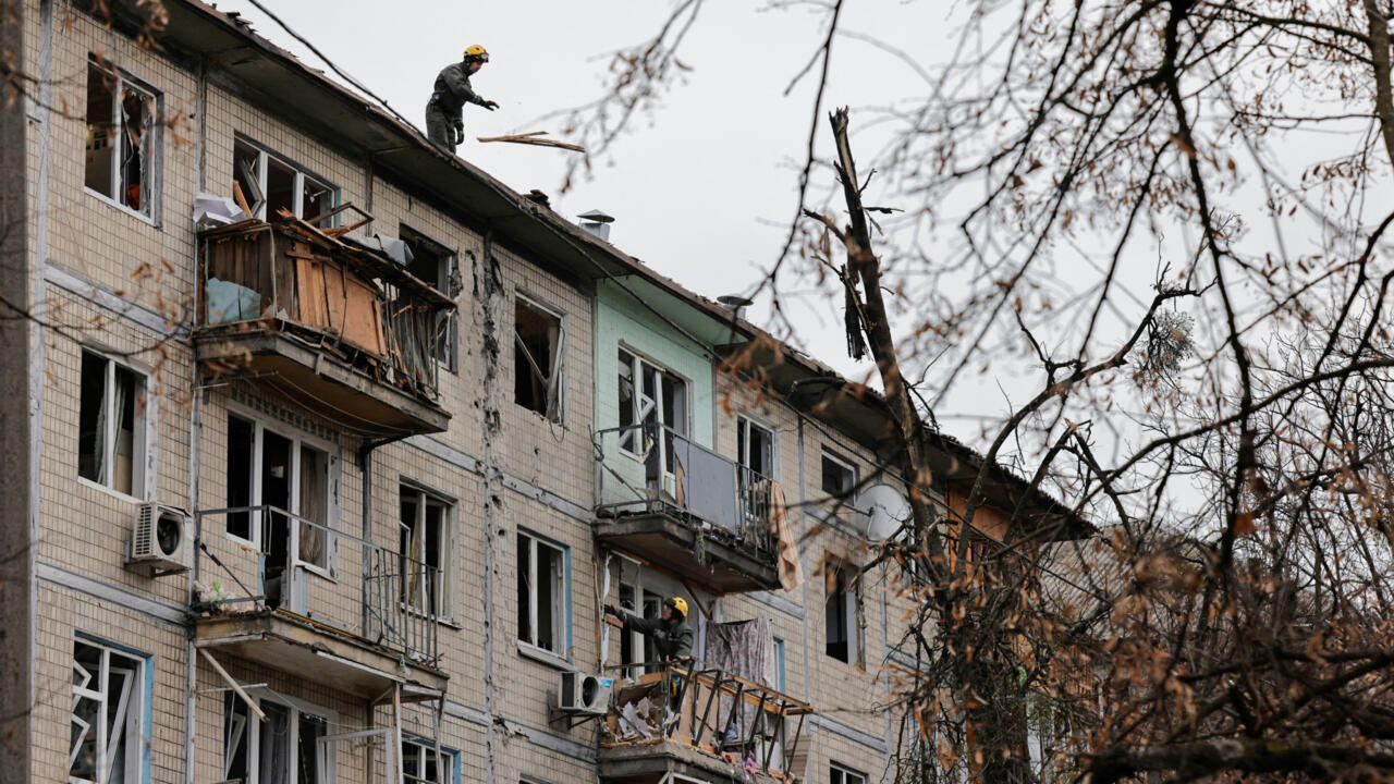 Emergency responders work at the site of a Russian drone strike on an apartment building, amid Russia's attack on Ukraine, in Kyiv, Ukraine December 23, 2025