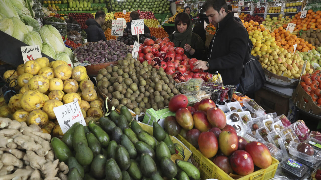 Shoppers inspect pomegranates, a main element of Yalda Night, in a fruit shop in northern Tehran, Iran, Saturday, Dec. 21, 2019. Every Dec. 21, Iranians commemorate the ancient and auspicious winter solstice, also known as Yalda Night, which is regarded as a felicitous farewell to fall. People munch on nuts and eat fresh fruits, especially pomegranate and watermelon, at extended family gatherings while marking the longest night of the year, a recognition of the symbolic victory of light over darkness. In the past, people listened to tales and poems recited by elders, which rarely happens in recent years. (AP Photo/Vahid Salemi)
