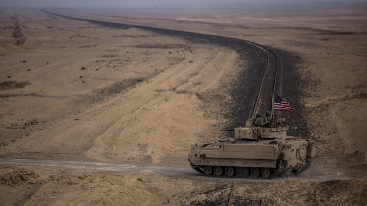 US soldiers drive a Bradley fighting vehicle during a joint exercise with Syrian Democratic Forces in the countryside of Deir Ezzor in northeastern Syria, December 8, 2021
