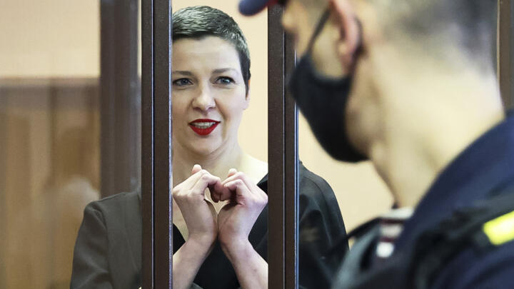 Belarus opposition activist Maria Kolesnikova stands behind bars in a defendants' cage in a court in Minsk, Belarus, on August 4, 2021