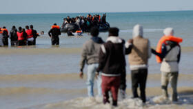 Migrants board a small boat to reach Britain on September 19, 2025, in Gravelines, France.