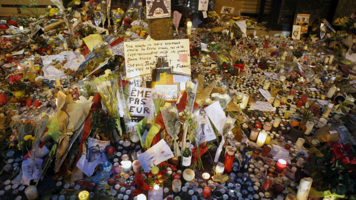 Flowers, pictures and candles are set in memory outside La Belle Equipe restaurant in Paris, one of the locations attacked, November 17, 2015.